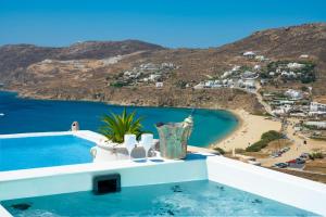 a view of the beach from a villa with a swimming pool at Margi Villas in Mýkonos City