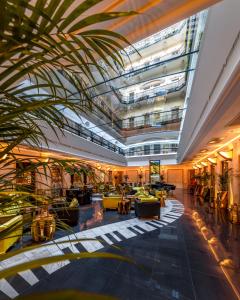 un vestíbulo con una palmera en un edificio en Aria Hotel Budapest by Library Hotel Collection en Budapest