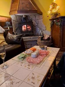 a living room with a table with food and a fireplace at Soupiets in Betpouey