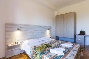 梵蒂冈角Residence Limoneto的卧室里有一张带木质床头板的大床 更多34张照片