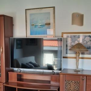 a large flat screen tv in a living room at The One in Baška Voda
