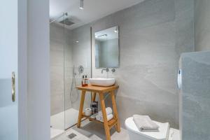 a bathroom with a sink and a shower at Thea Eco Suites in Nea Kallikrateia