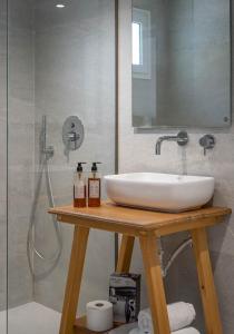 a bathroom with a sink and a shower at Thea Eco Suites in Nea Kalikratia