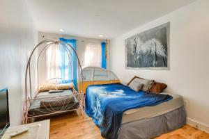 a bedroom with two beds and a horse picture on the wall at Quirky Baltimore Townhome about 2 Mi to Inner Harbor in Baltimore