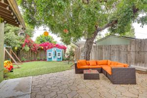 an orange couch sitting under a tree in a backyard at California Abode Near Universal Studios Hollywood! in Los Angeles