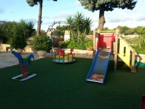 a playground with a slide and a slideintend at Masseria Nzeta in Carovigno