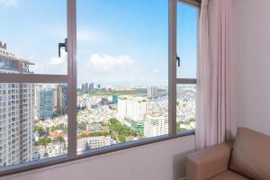 a room with two windows with a view of a city at YO's Homes Rivergate Apartment Infinity Pool Near District 1 in Ho Chi Minh City