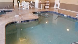 a large swimming pool in a hotel room at GrandStay Residential Suites Hotel - Eau Claire in Eau Claire