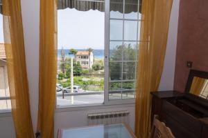a window with a view of the ocean at Casa Ambra mare in Bordighera