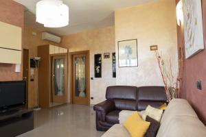 a living room with a couch and a television at Casa Ambra mare in Bordighera