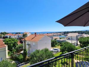 a view of a city from a balcony at Modern studio with a beautiful view in Rab