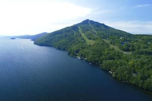 an aerial view of a lake with a mountain at Destination Owl's Head - Mtn Haus in Mansonville
