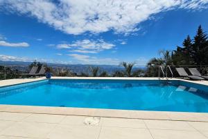 a large blue swimming pool with a view at Villa Alba, Apartment Katja - with swimming pool in Ičići