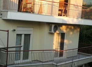 a balcony of a building with an air conditioner at Melistalia apartment 2 in Nea Michaniona