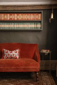 a red couch in a living room with a shelf at Plum Bray in Bray