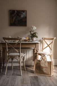 a dining room with a table and two chairs at Plum Bray in Bray