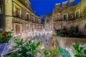 an alley in an old building with lights at CASA NINNI in Catania