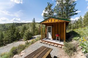 a tiny house on a hill with a bench at Echo Valley Resort + Cabins in Manson