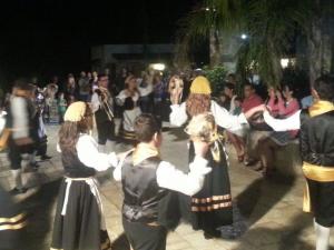 a group of people in medieval costumes performing a dance at Masseria Nzeta in Carovigno