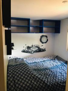 a bedroom with a bed with blue bunk beds at Mobil-home sur terrain privé in Sérignan