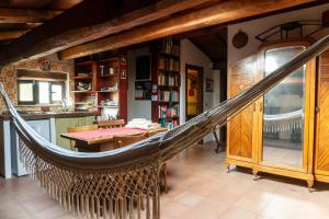 a hammock in a room with a kitchen at Country House tra lago e mare a Sud di Roma in Campoleone