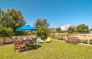 a patio with a table and chairs and an umbrella at Johnhara Studios & Apartments in Ialysos