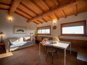 a living room with a couch and a table at Podere le Mezzelune in Bibbona