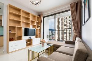 a living room with a couch and a large window at YO's Homes Rivergate Apartment Infinity Pool Near District 1 in Ho Chi Minh City