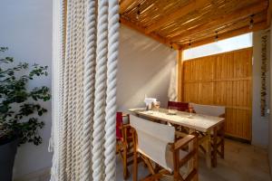 a dining room with a table and chairs at VICANTI Luxury Apartments in Pylos