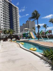 a swimming pool with yellow rafts in a city at SALINAS EXCLUSIVE RESORT in Salinópolis