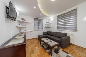 a living room with a couch and a tv at Port 1 in Belgrade