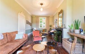 a living room with a couch and a fireplace at Beautiful Home In Fressin With Kitchen in Fressin