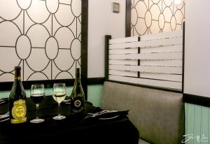 two glasses of wine on a table in a restaurant at Sternwheeler Hotel & Conference Centre, Trademark by Wyndham in Whitehorse