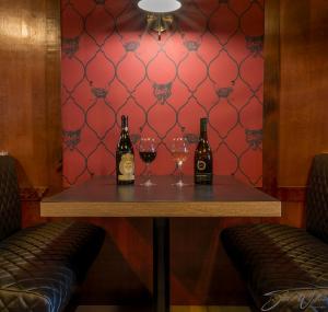 a table with two bottles and glasses of wine at Sternwheeler Hotel and Conference Centre in Whitehorse