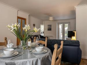 a living room with a table and a couch at Madryn in Clynnog-fawr