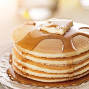 a stack of pancakes on a plate with chocolate at Sheraton Eatontown Hotel in Eatontown