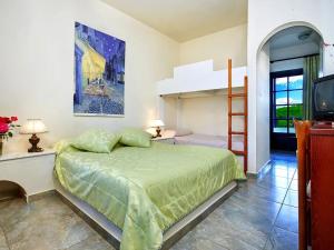 a bedroom with a bed and a bunk bed at Assa Maris Beach Hotel in Pyrgadikia