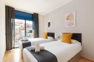 Postel nebo postele na pokoji v ubytování Lucas House Apartments by Sitges Group