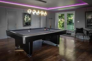 a billiard room with a pool table and purple lighting at Spengarth House by STAMP SA in Blackpool