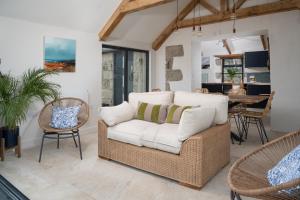 a living room with a couch and chairs and a table at The Rum House in Helston