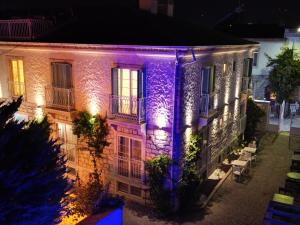 a building with purple lights on it at night at Mavi Konak Alaçatı in Alaçatı