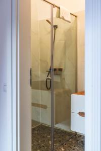 a shower with a glass door in a bathroom at Sia Boutique Aparthotel in Sibiu +42 photos