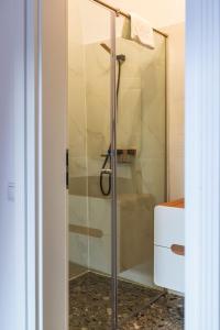 a shower with a glass door in a bathroom at Sia Boutique Aparthotel in Sibiu