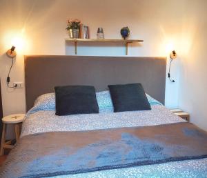 a bedroom with a bed with two pillows on it at Large flat in the hills of Menaggio in Menaggio