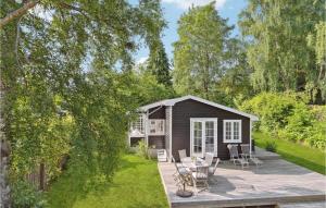 a small shed with a deck in a garden at Awesome Home In Hornbk With Wifi in Hornbæk
