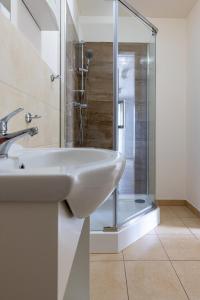 a bathroom with a sink and a shower at Pokoje gościnne Anna in Rewa +49 photos