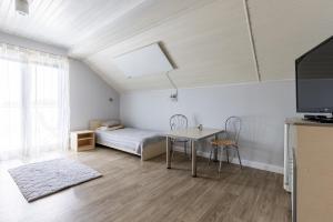 a living room with a bed and a table at Pokoje gościnne Anna in Rewa