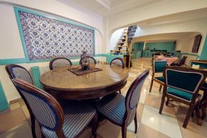 a dining room with a wooden table and chairs at Sufi Homes in Konya