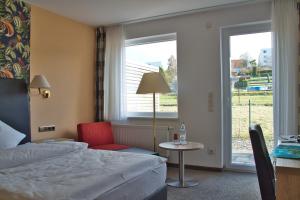 Postel nebo postele na pokoji v ubytování Hotel Quellenhof