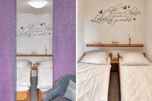 a bedroom with two beds with purple curtains and a chair at Terrassenhaus, FeWo 78 in Duhnen